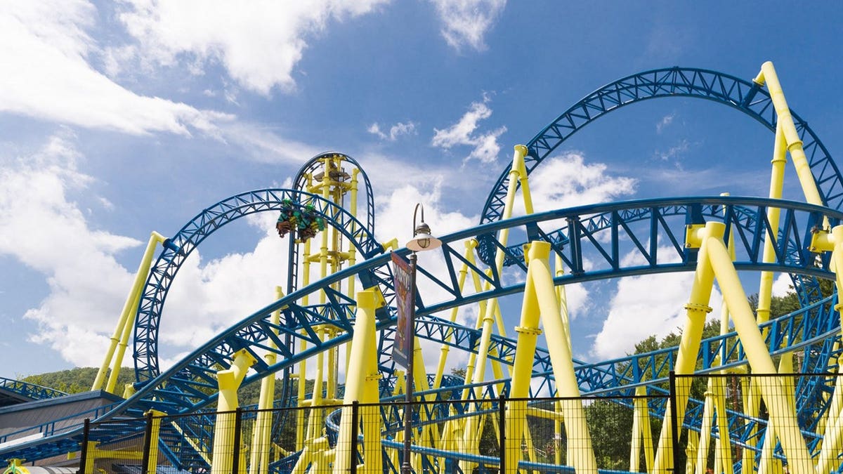 View of steel blue and yellow rollercoaster at Knoebels
