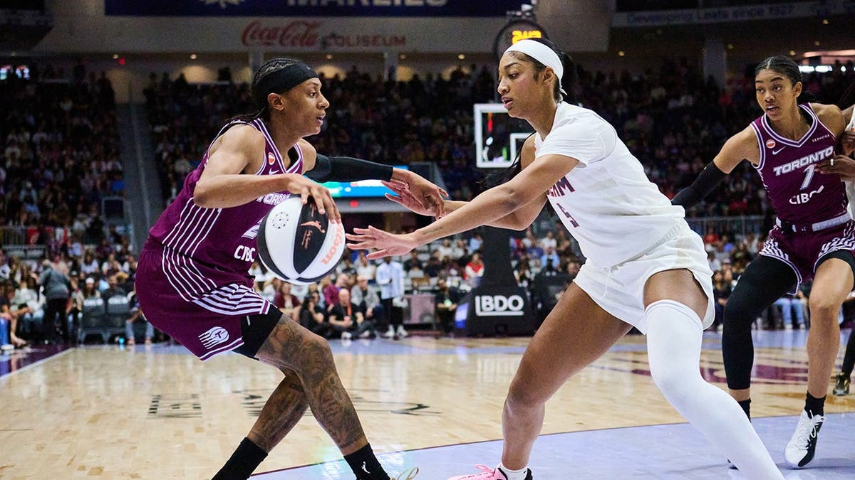 Toronto Tempo's Brittney Sykes defending against Atlanta Dream's Angel Reese during a basketball game in Toronto