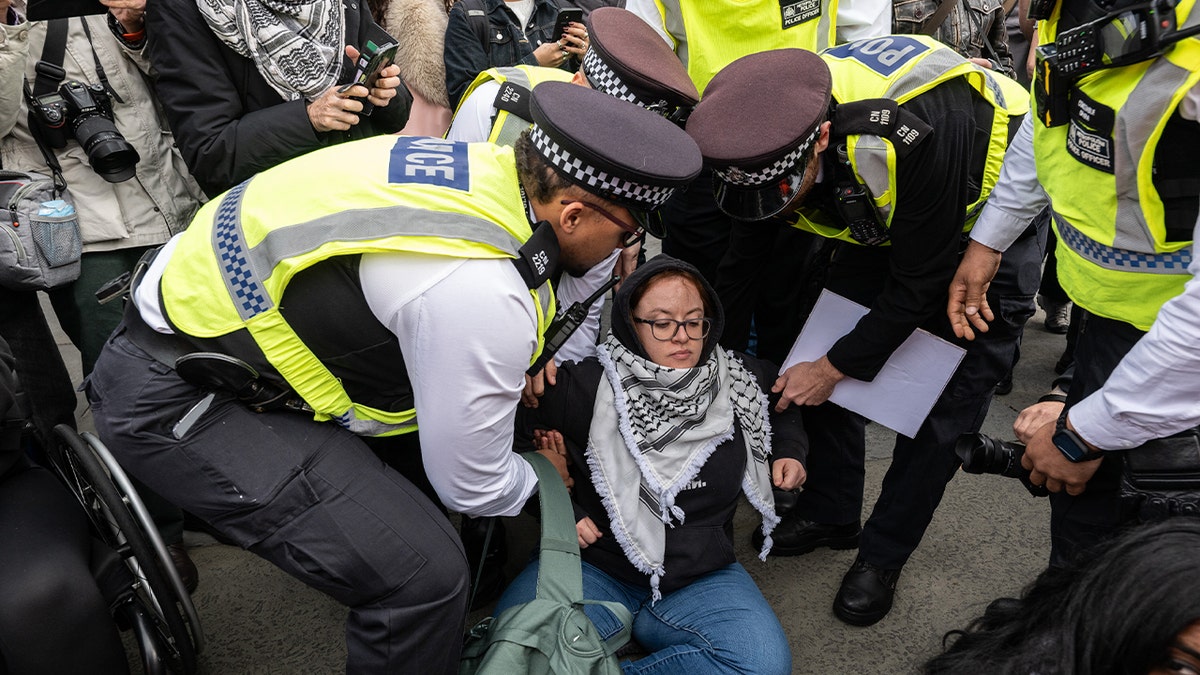 Police arrest an activist in Trafalgar square for defying the Palestine Action ban on October 4, 2025 in London.