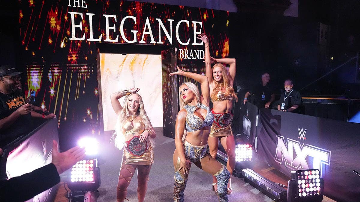 Ash By Elegance accompanied by Heather Reckless and M By Elegance walking to the ring at Lowell Memorial Auditorium.