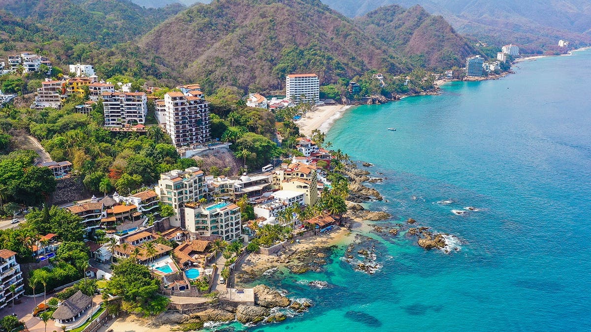 Conchas Chinas Beach with golden sands and rock formations in Puerto Vallarta Mexico