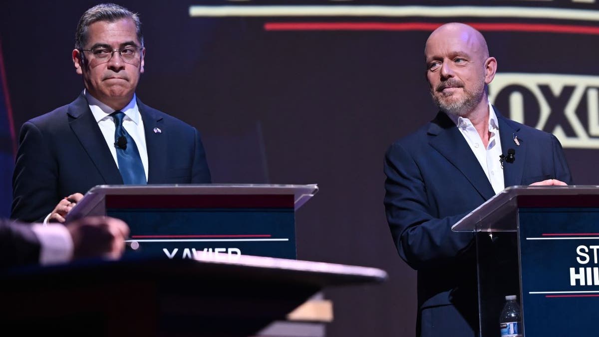 Xavier Becerra and Steve Hilton participating in a debate in San Francisco