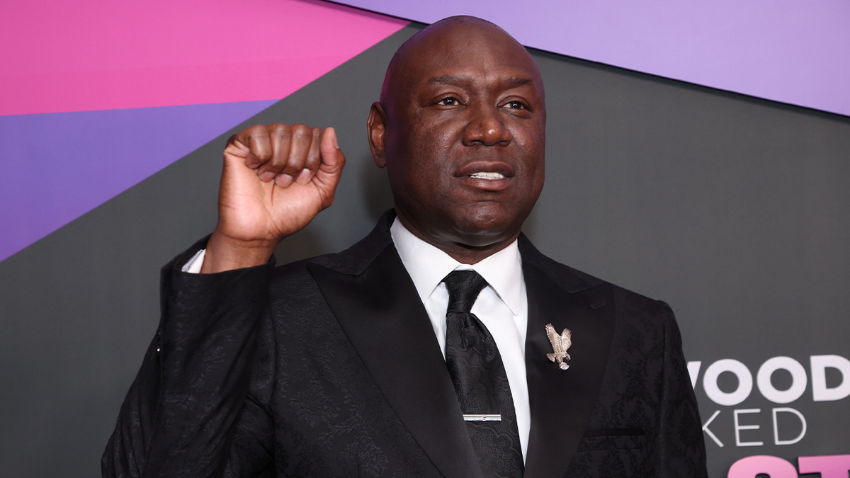 Attorney Ben Crump raising fist at Hollywood Unlocked's Fourth Annual Impact Awards in Beverly Hills