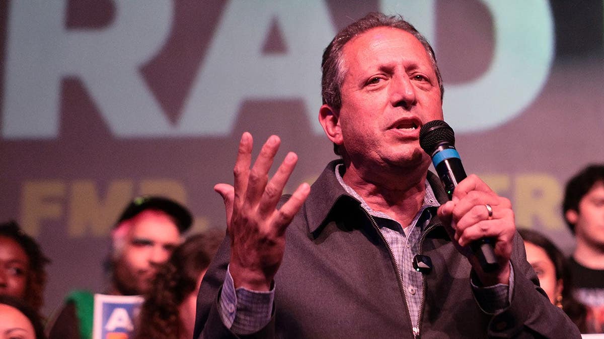 Democratic candidate Brad Lander speaking on stage at an election rally in Brooklyn