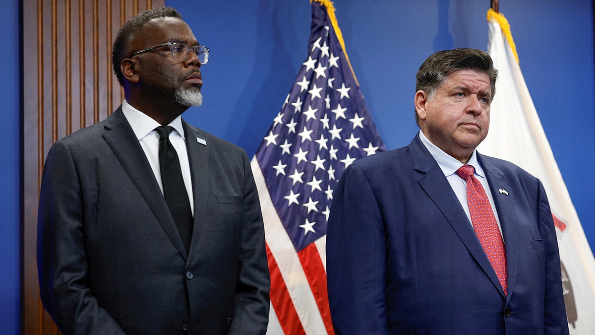 Chicago Mayor Brandon Johnson and Illinois Gov. JB Pritzker standing together at a press conference.
