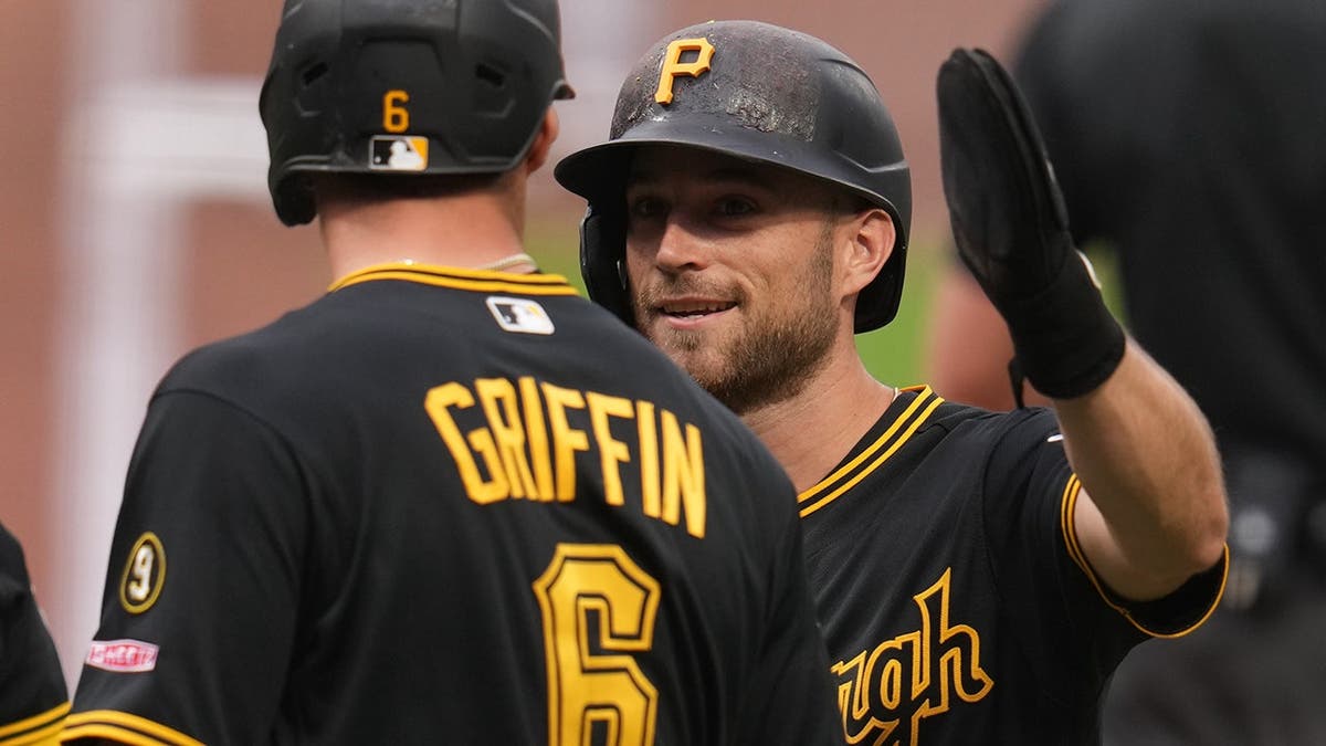 Pittsburgh Pirates' Brandon Lowe celebrating with Konnor Griffin during a baseball game.