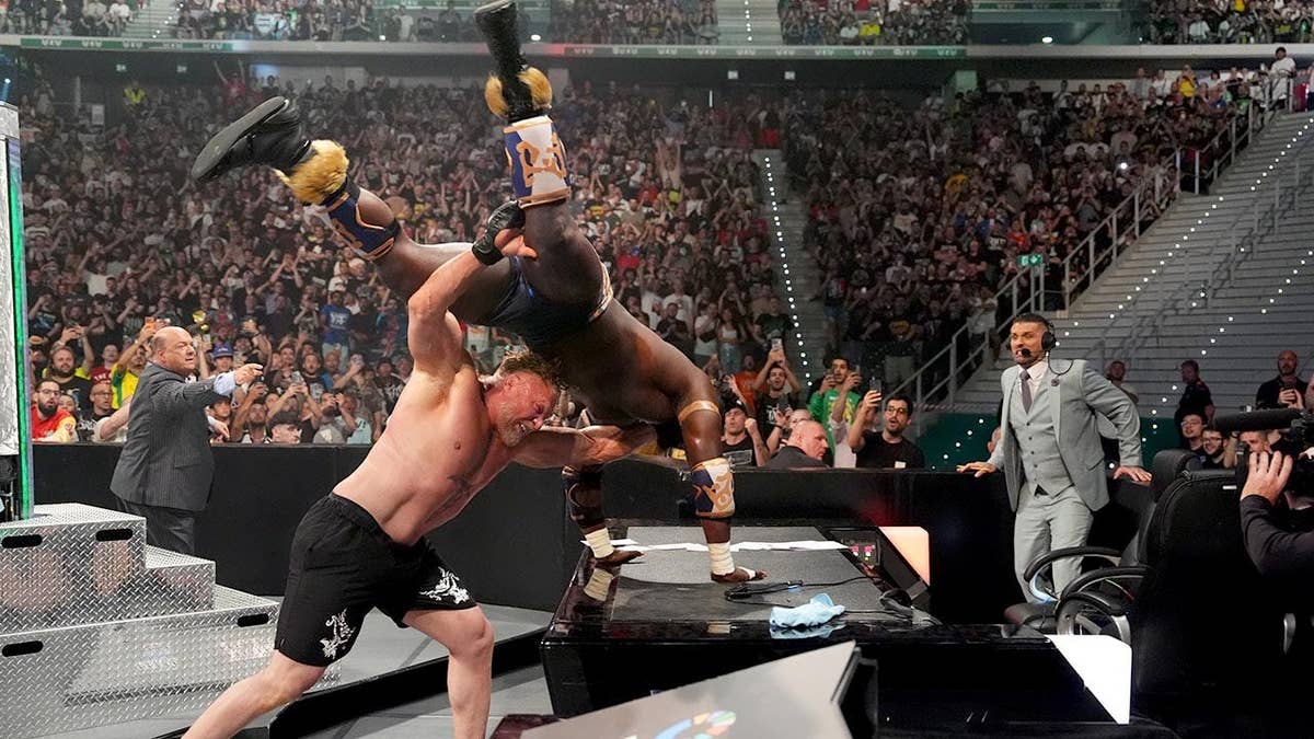 Brock Lesnar performing an F5 on Oba Femi on an announce table in Torino di Sangro