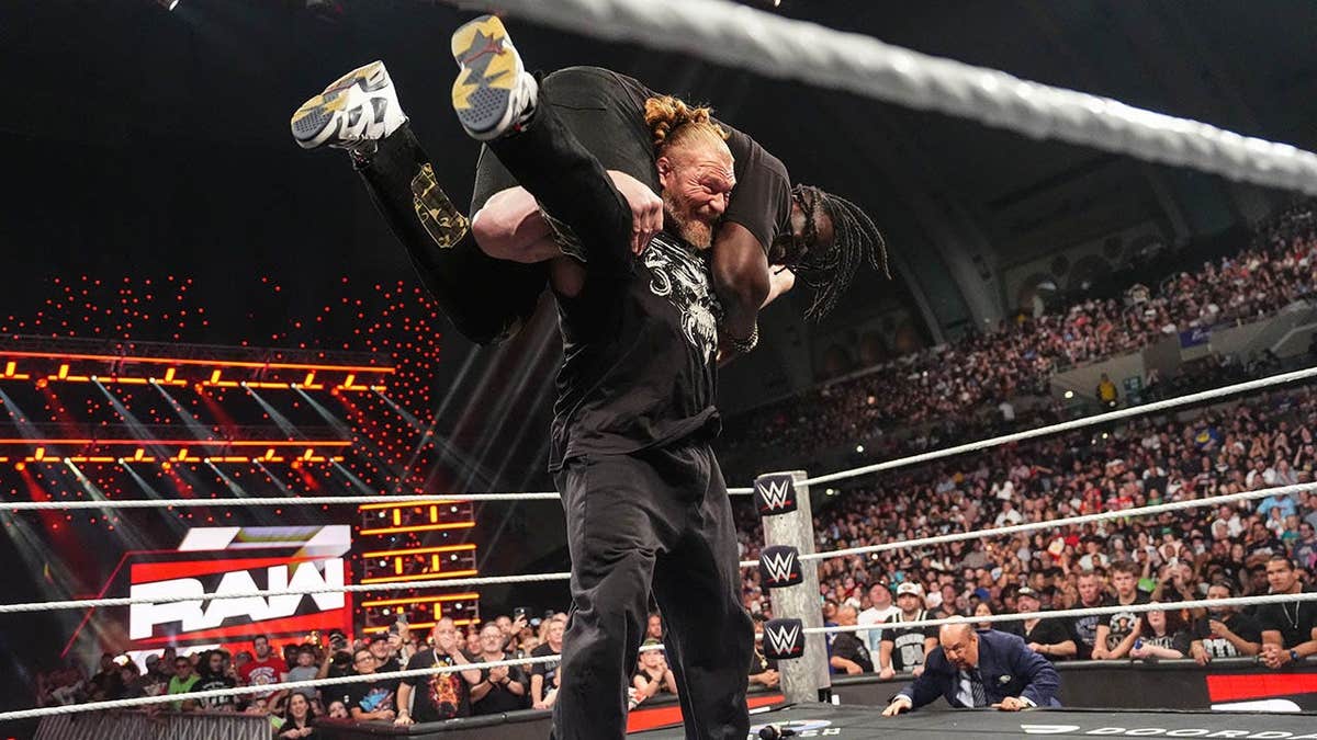 Brock Lesnar wrestling Oba Femi in a wrestling ring at Boardwalk Hall Arena