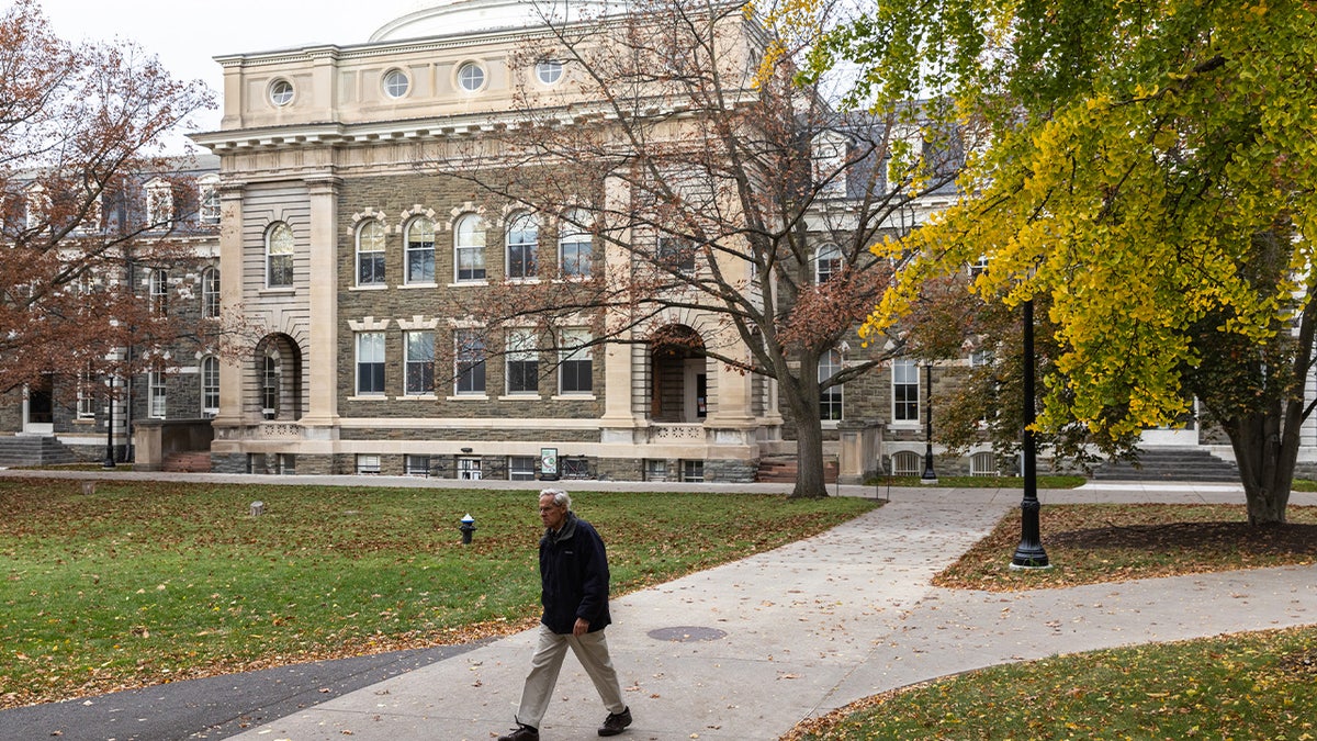 A man walking through the Cornell University campus in Ithaca, New York.