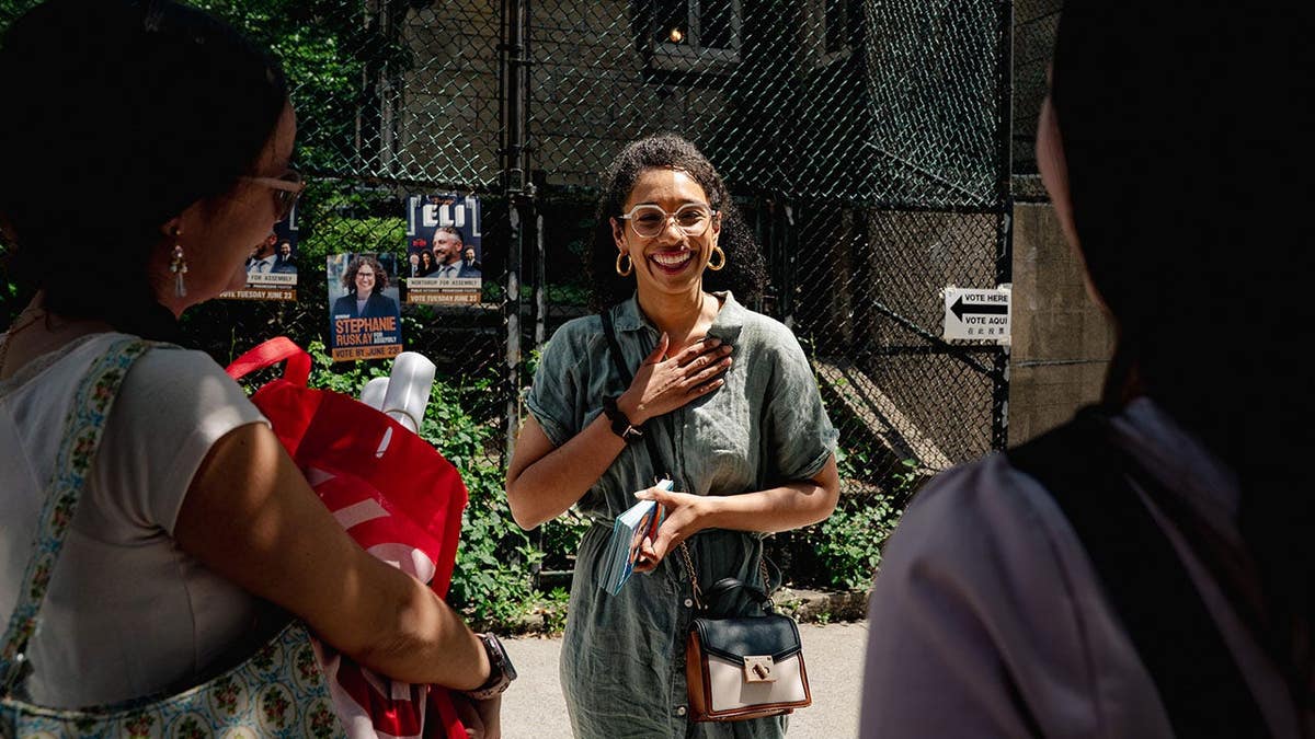 Darializa Avila Chevalier speaking with a voter in Morningside Heights Manhattan