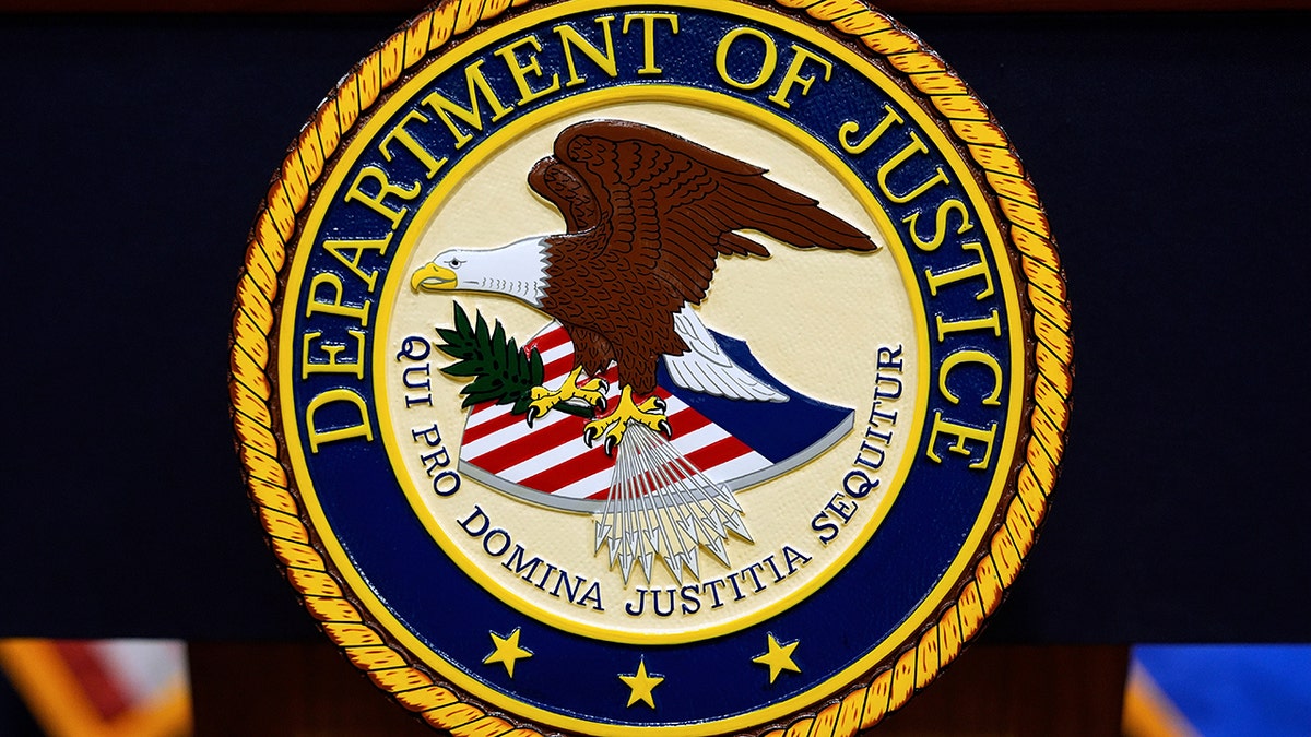 U.S. Department of Justice logo on a podium at a press conference