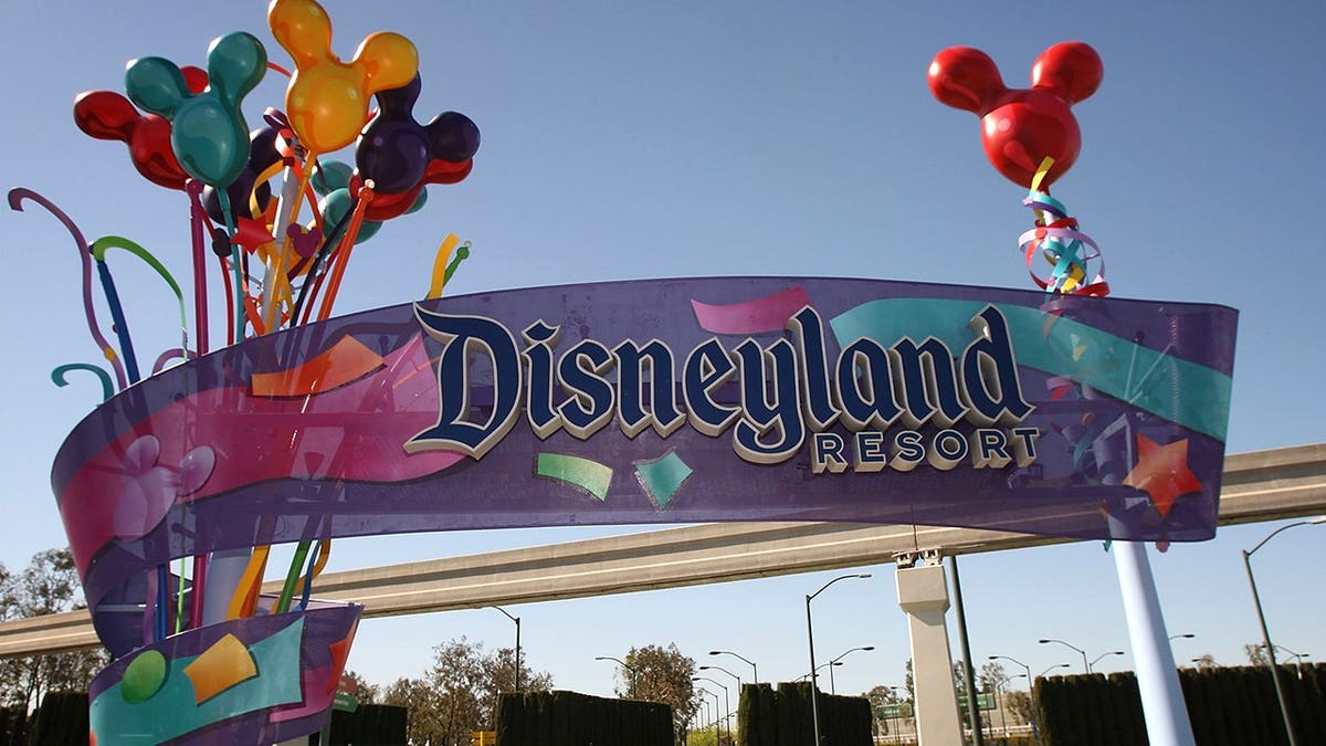 Pedestrians walking near the entrance to Disneyland Resort in Anaheim, California