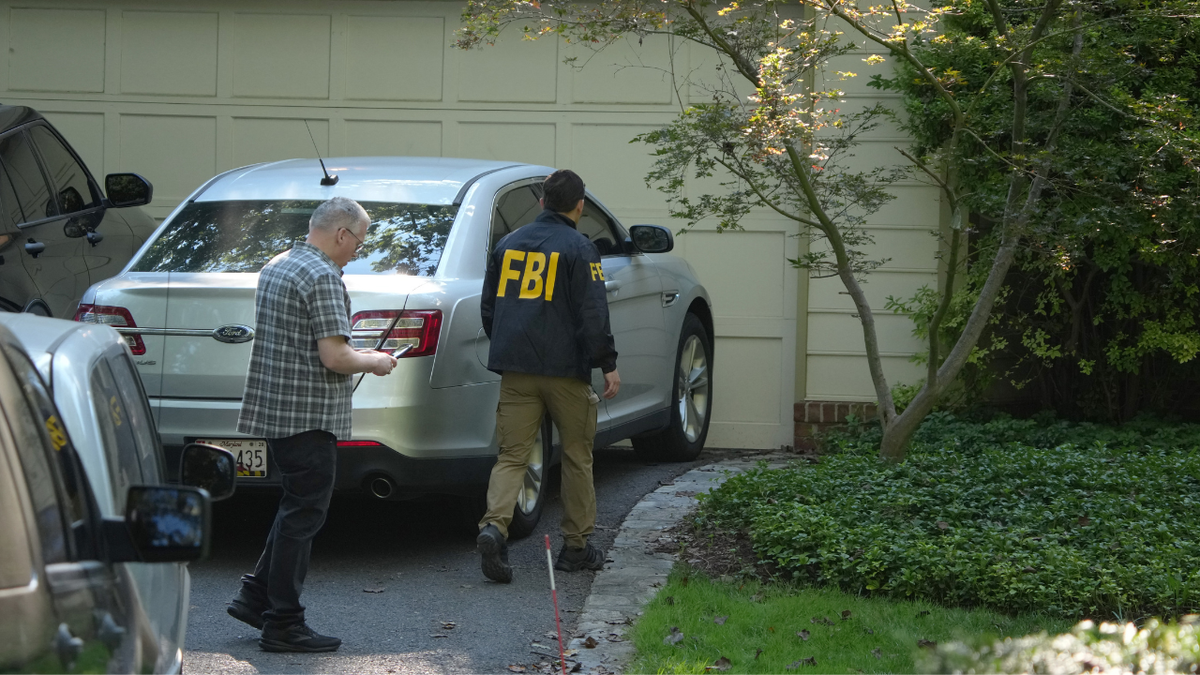 FBI agents outside John Bolton's home