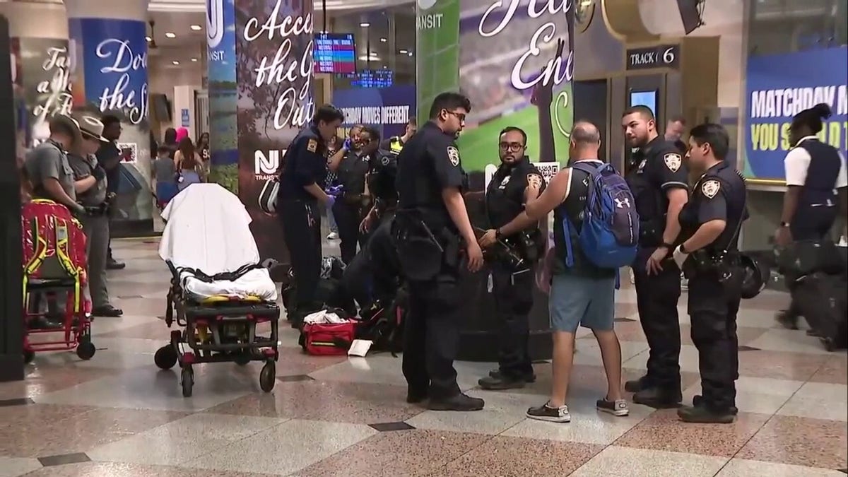 Police officers and emergency personnel respond inside Penn Station after multiple people were stabbed.