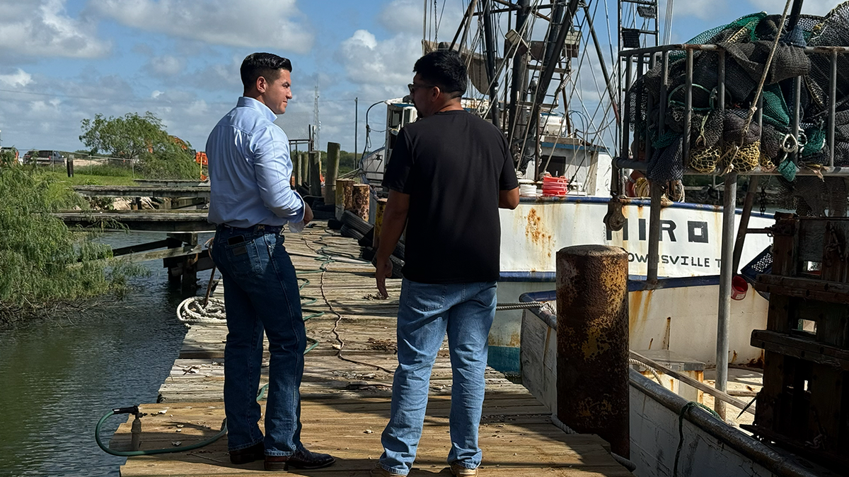 Eric Flores speaking with shrimping business owner