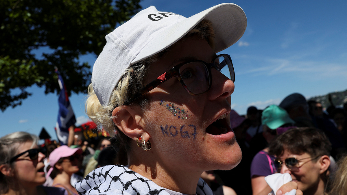 People attend a protest against the upcoming G7 summit in Evian-les-Bains in France, in Geneva, Switzerland