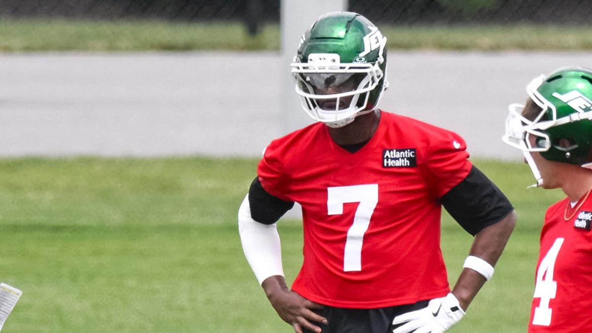 New York Jets quarterbacks Geno Smith and Brady Cook participate in a drill at minicamp.
