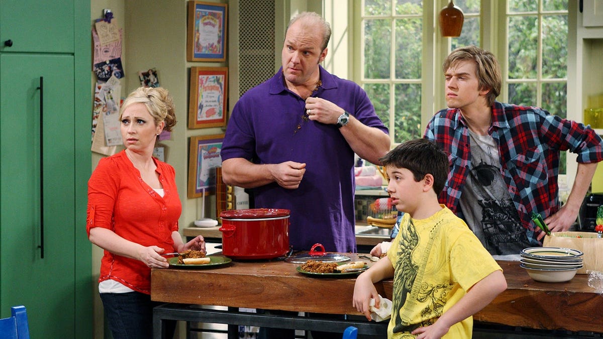 Leigh-Allyn Baker, Eric Allan Kramer, Bradley Steven Perry, and Jason Dolley standing together on set