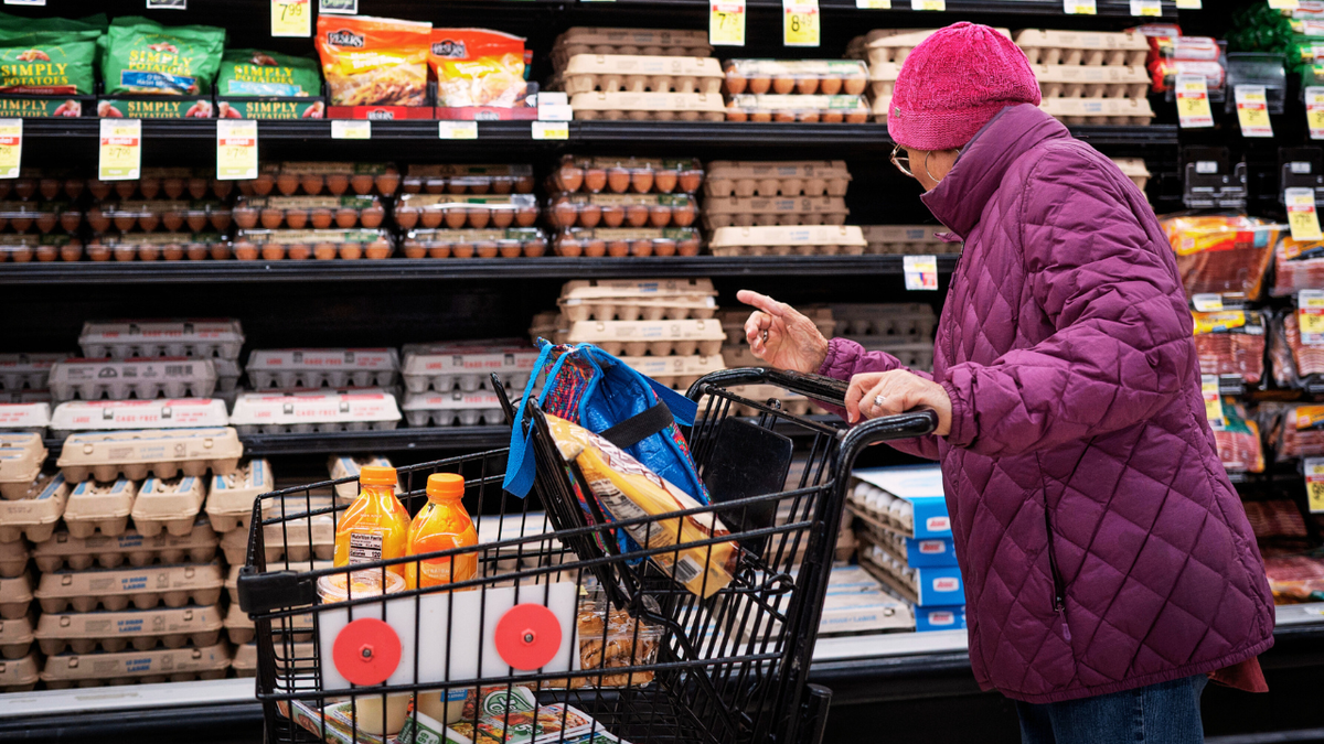 A woman looks at egg prices at a grocery store in Chicago, Illinois.