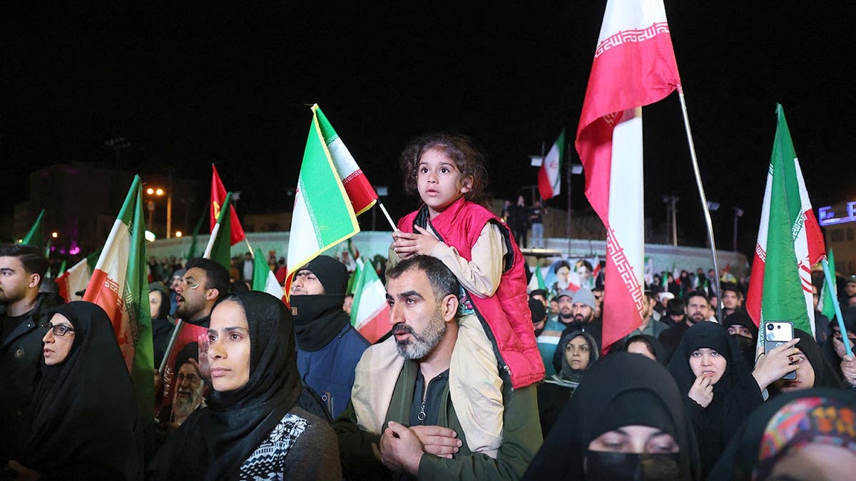 Iranians gathering in Enqelab Square to react to a ceasefire announcement.
