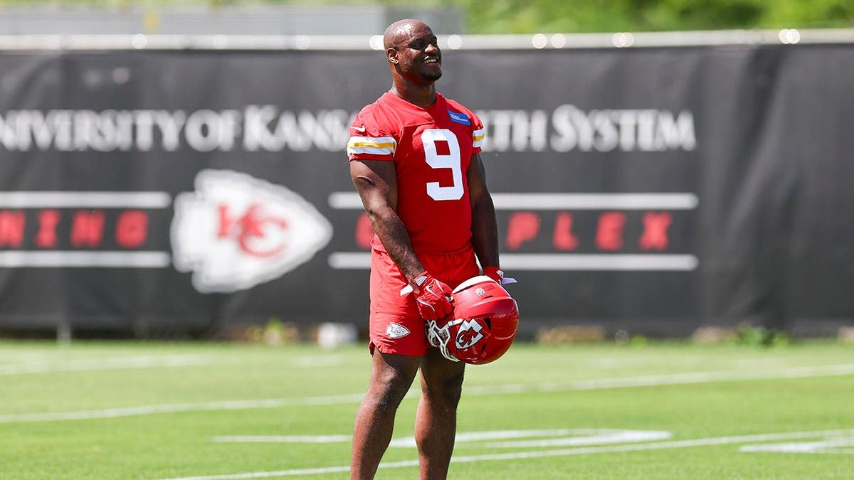Kenneth Walker wearing number 9 jersey participating in minicamp at training complex.