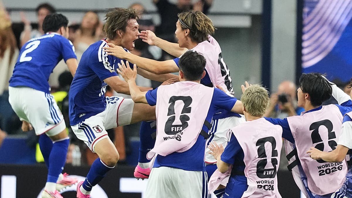 Japan's Koki Ogawa celebrates with teammates during a World Cup soccer match in Arlington, Texas.