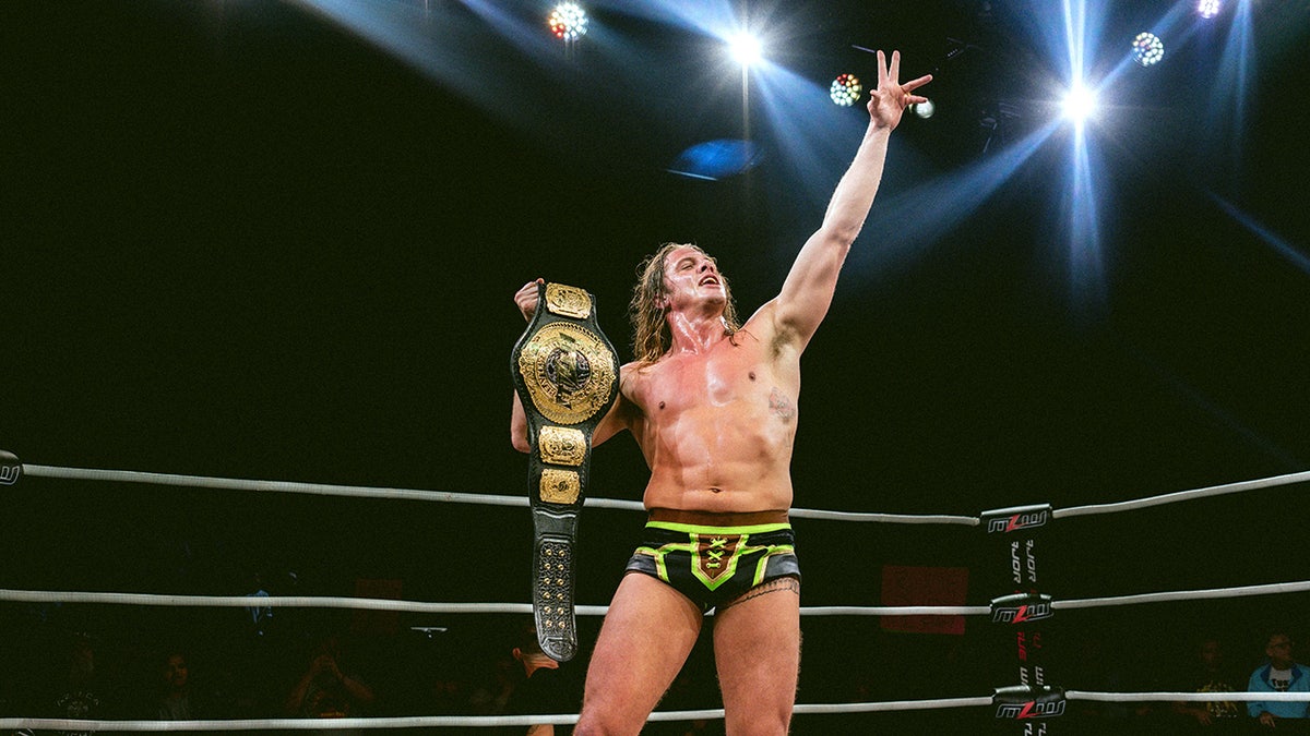 Matt Riddle holding the MLW title belt.