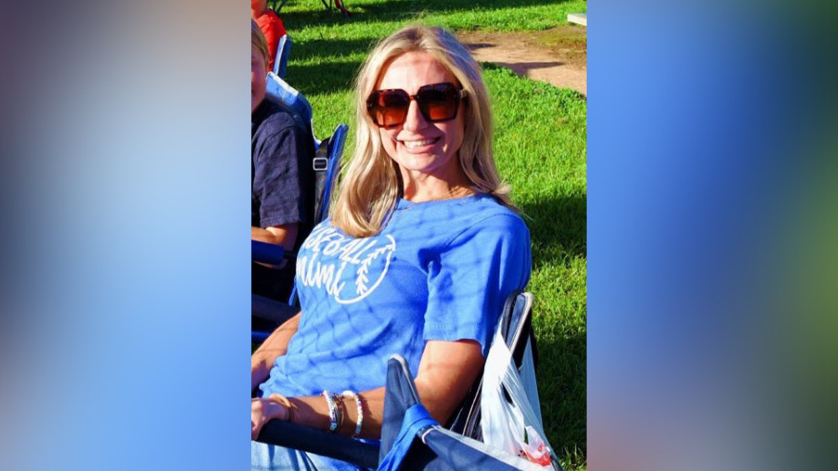 Misty Roberts standing and smiling in a portrait-style photo.