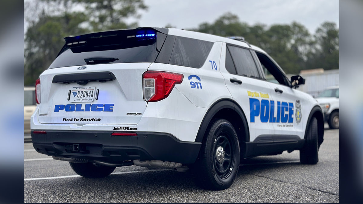 Myrtle Beach police cruiser parked on street at night