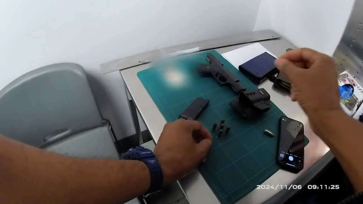 A glock handgun, magazine and cartridges on a table at TSA checkpoint