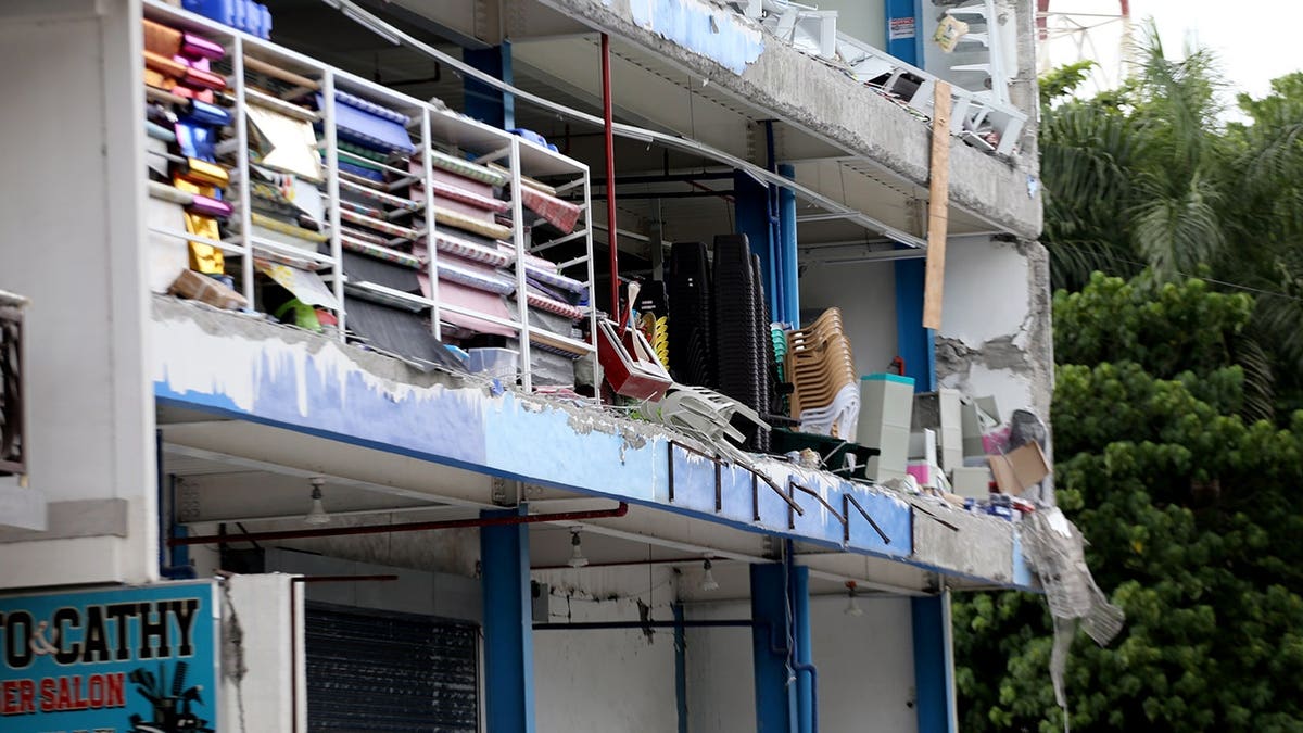 The side of a building shows damage from an earthquake.