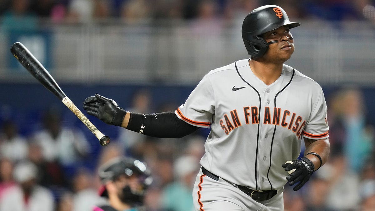 San Francisco Giants' Rafael Devers watching after hitting a home run during a baseball game.