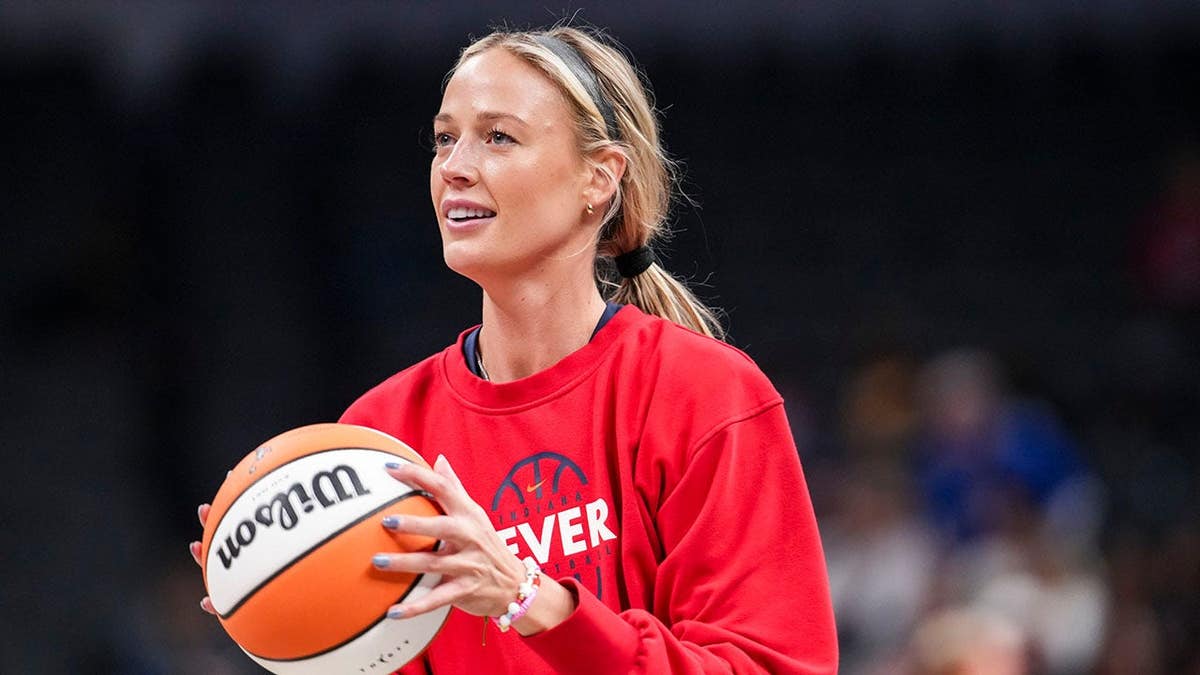 Indiana Fever guard Sophie Cunningham warming up on basketball court