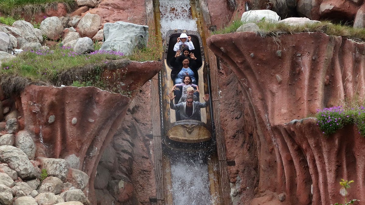People riding the Splash Mountain attraction at Disneyland in Anaheim, California