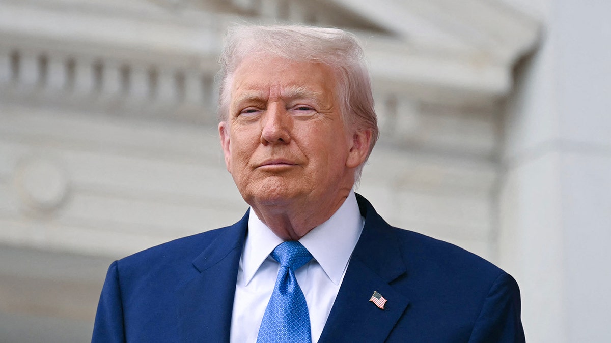 President Donald Trump walking at Arlington National Cemetery Memorial Amphitheatre