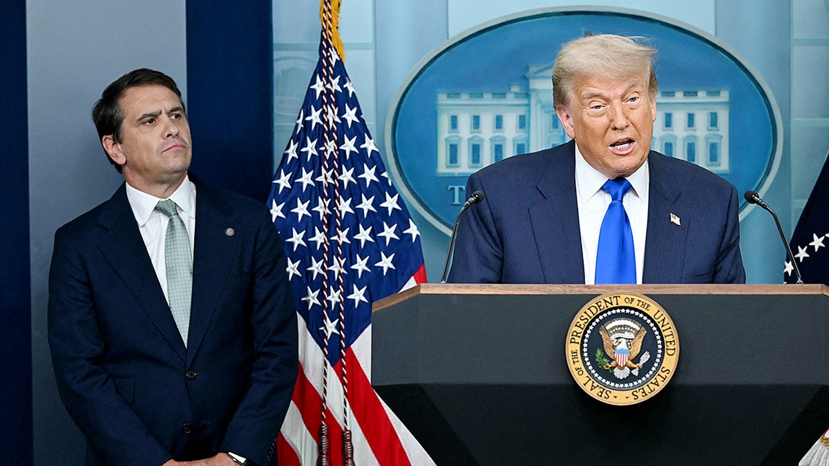 President Donald Trump speaking alongside Deputy Attorney General Todd Blanche in the White House briefing room