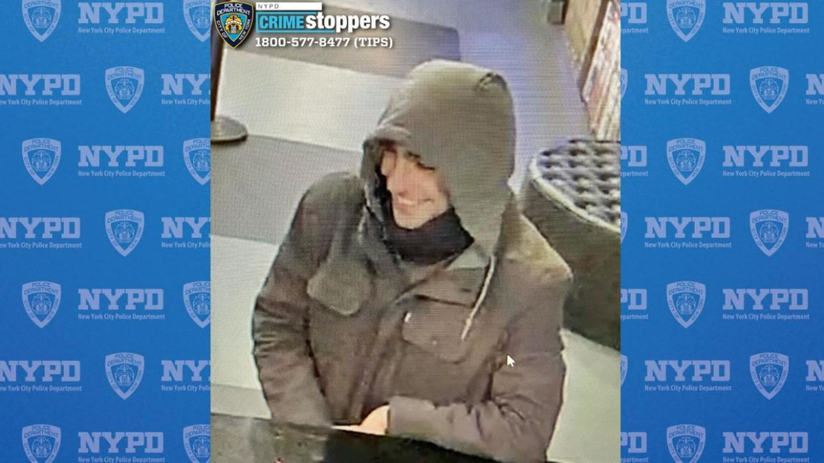 Luigi Mangione smiling and talking to a hostel employee on surveillance footage