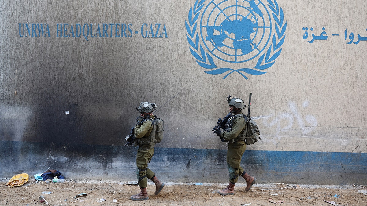 Israeli soldiers standing inside an evacuated UNRWA compound in Gaza City