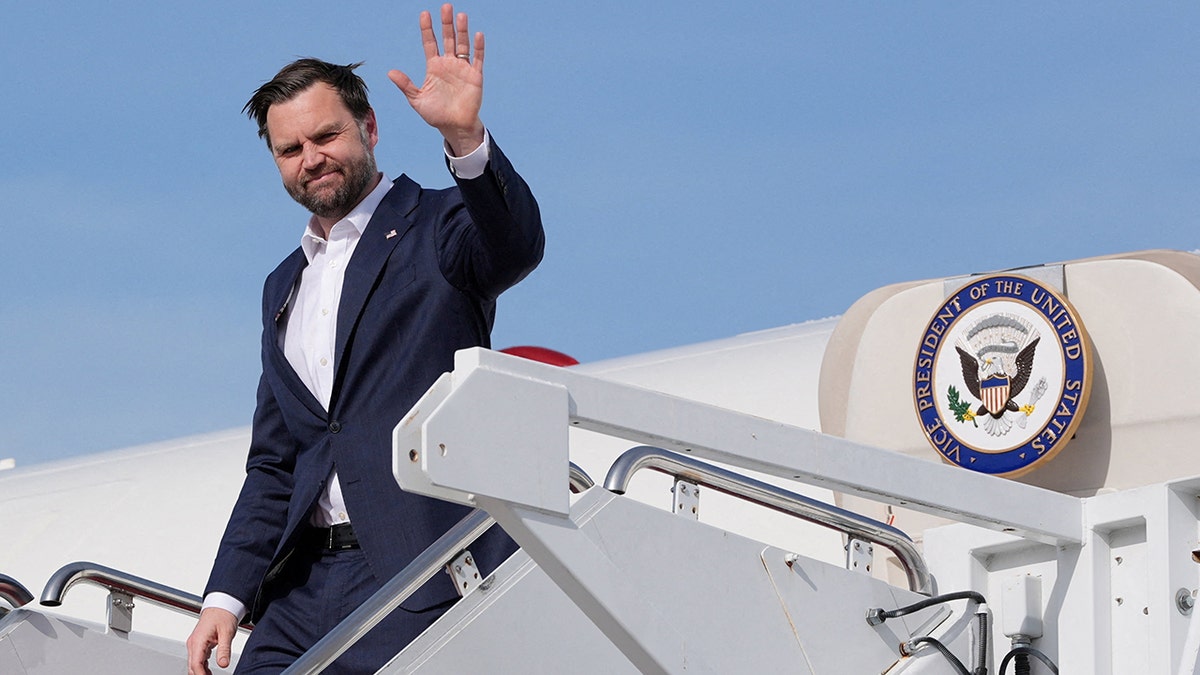 Vice President JD Vance walking down stairs of Air Force Two at an airfield