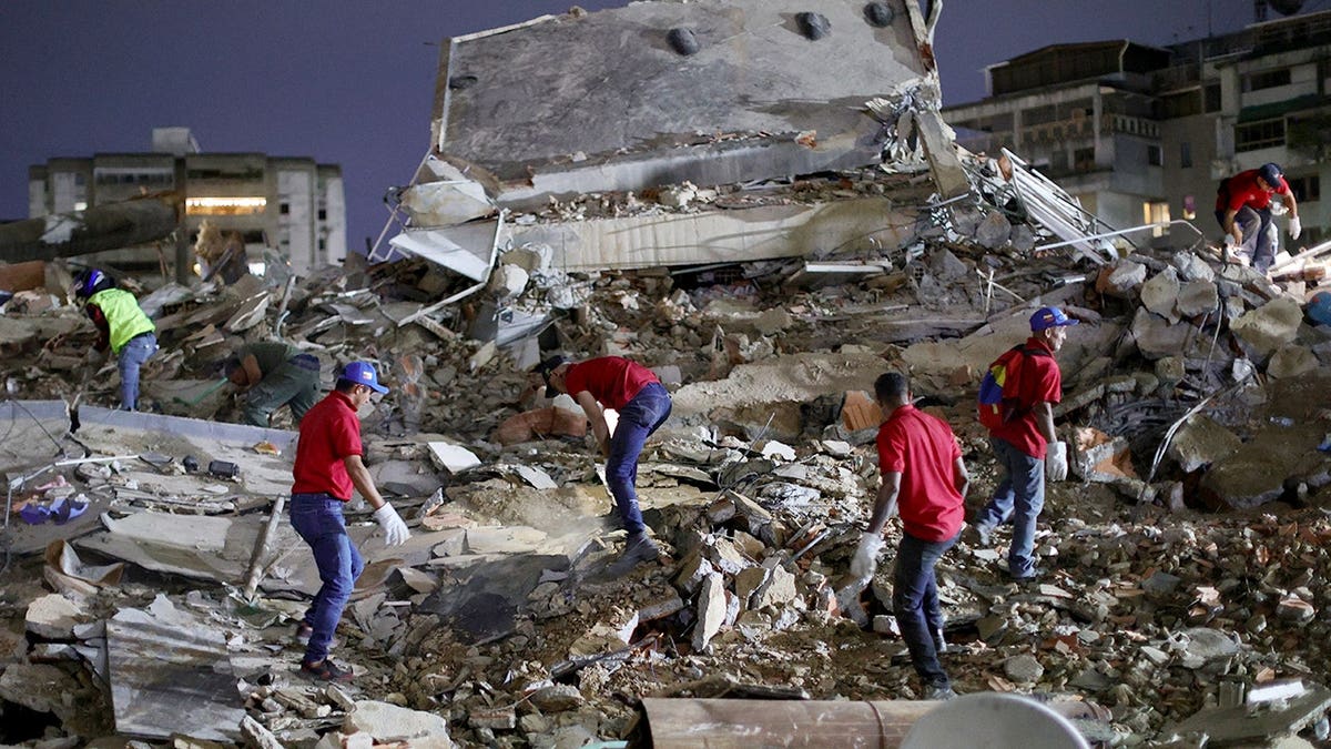 Responders searching for victims in a demolished building in Caracas, Venezuela