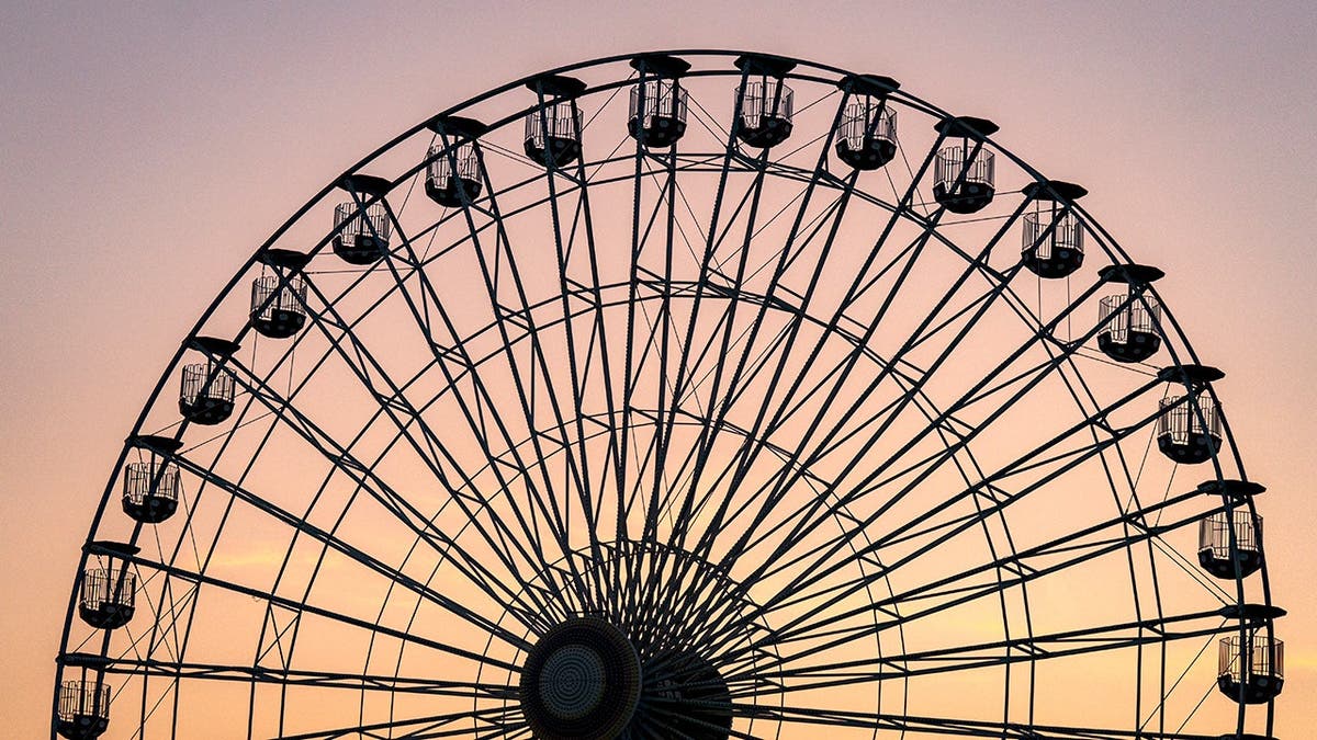 Gillian's Wonderland Pier's Giant Wheel is shown with a sun setting in the background.
