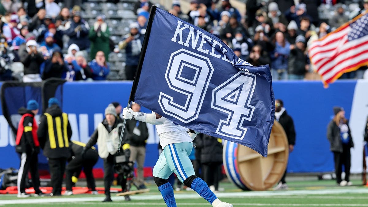 Osa Odighizuwa with Marshawn Kneeland flag