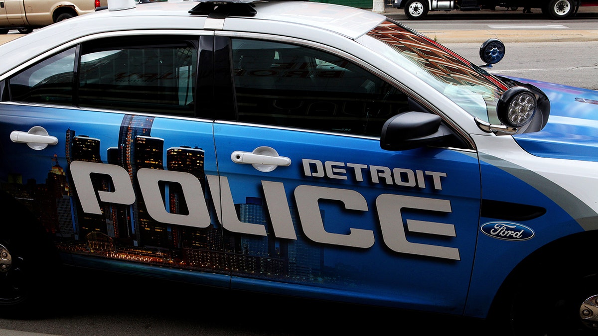 A Detroit police car parked on a downtown street.