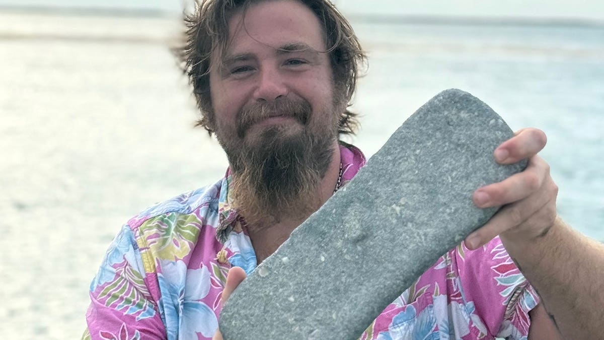 Captain Drake holding silver bar