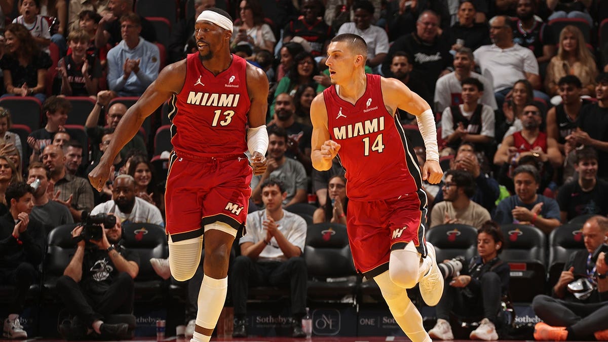 Bam Adebayo and Tyler Herro look on during a game in Miami.