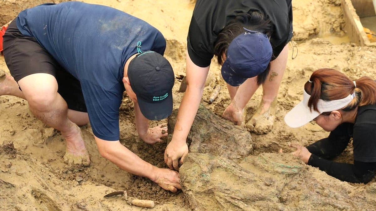 Archaeologists digging at Thai site for gold rings