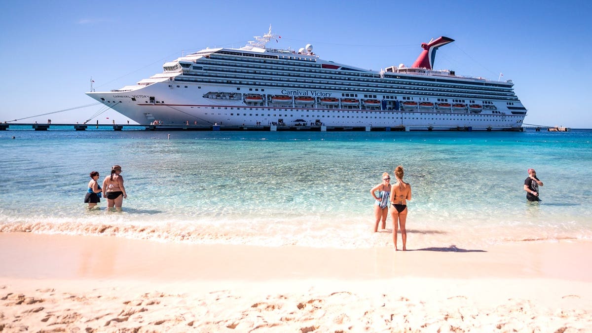 Tourists standing on Turks and Caicos beach