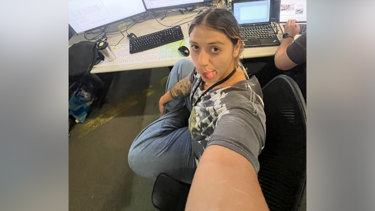 Victoria Castle poses for a selfie in front of a computer