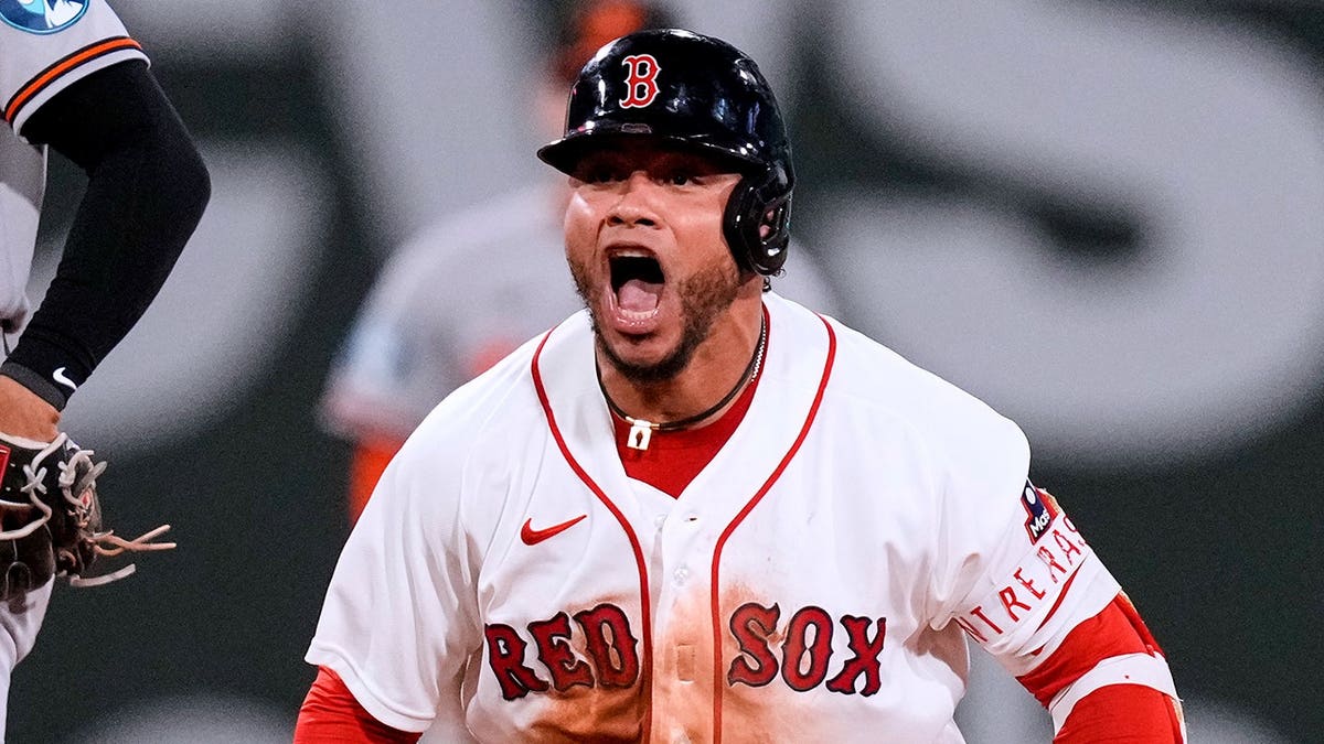 Willson Contreras celebrates after an RBI double in Boston.