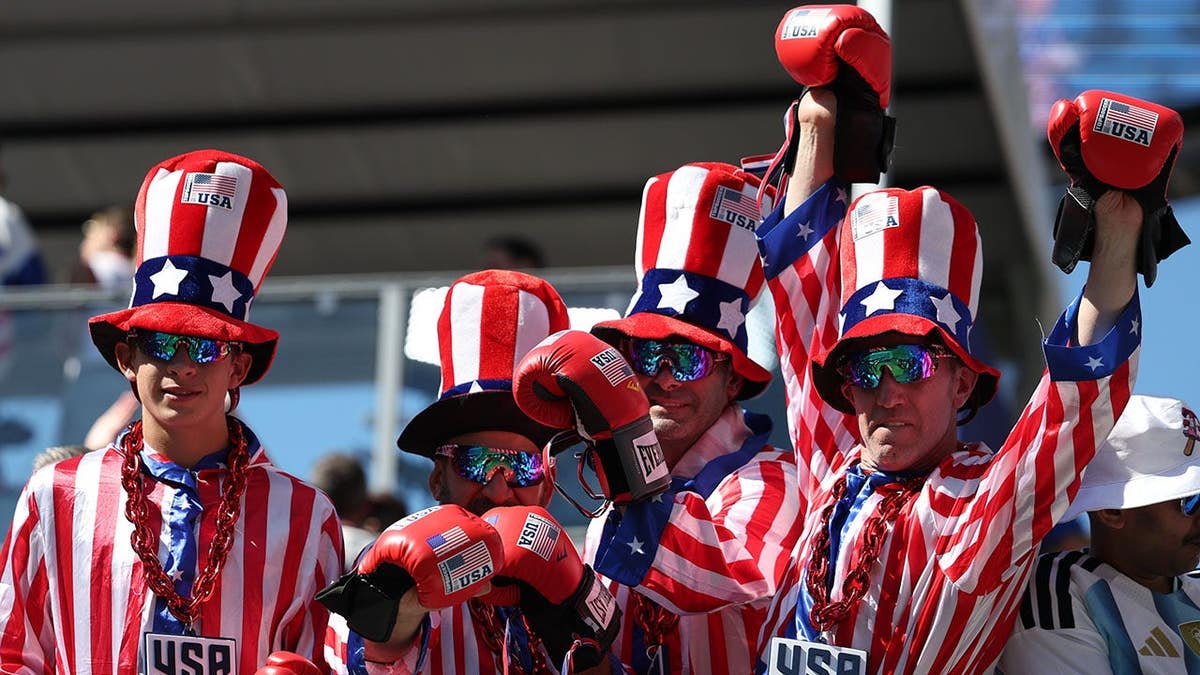 Fans react before the World Cup round of 16 soccer match between the United States and Belgium in Seattle.